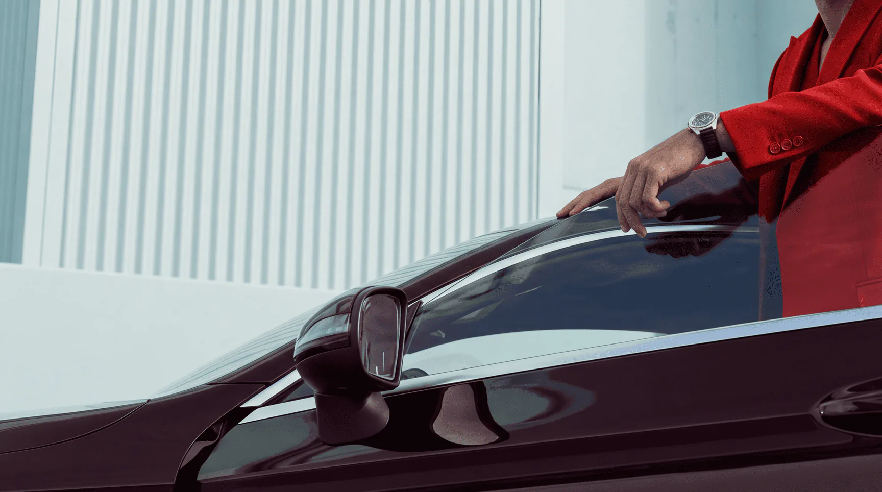 Person standing beside a black car